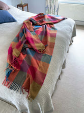 Colourful check merino lambswool throw on a bed