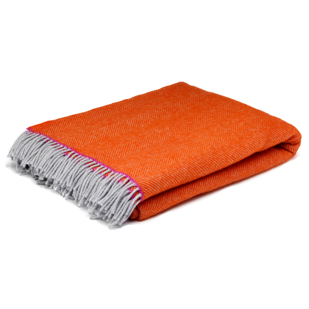Orange herringbone wool blanket with pink highlight and grey tassels