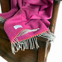 Pink wool throw on an antique wooden chair