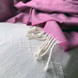 Tassels on pink inerior wool throw