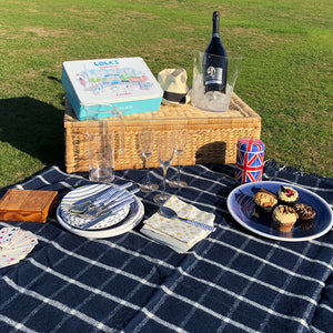 Navy blue wool picnic blanket spread out in a field