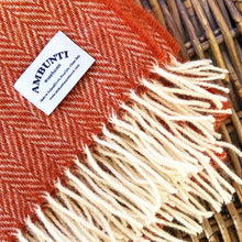 Orange herringbone wool throw by Ambunti Warehouse