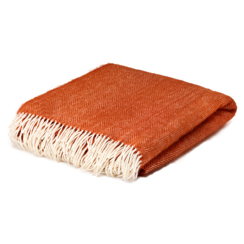 Orange herringbone wool throw blanket folded up