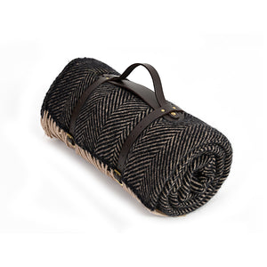 Brown herringbone waterproof wool picnic blanket with leather carry straps.