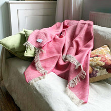 Pink linen throw on a white sofa with some scatter cushions