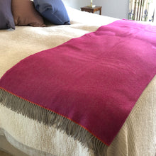 Pink wool blanket throw on a bed
