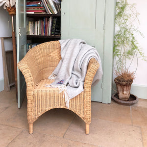 grey beehive wool throw draped over a conservatory chair