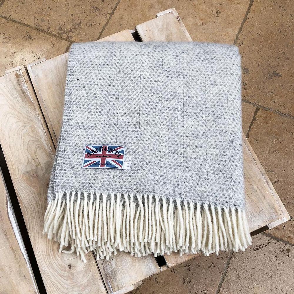 grey welsh wool throw folded up on a coffee table